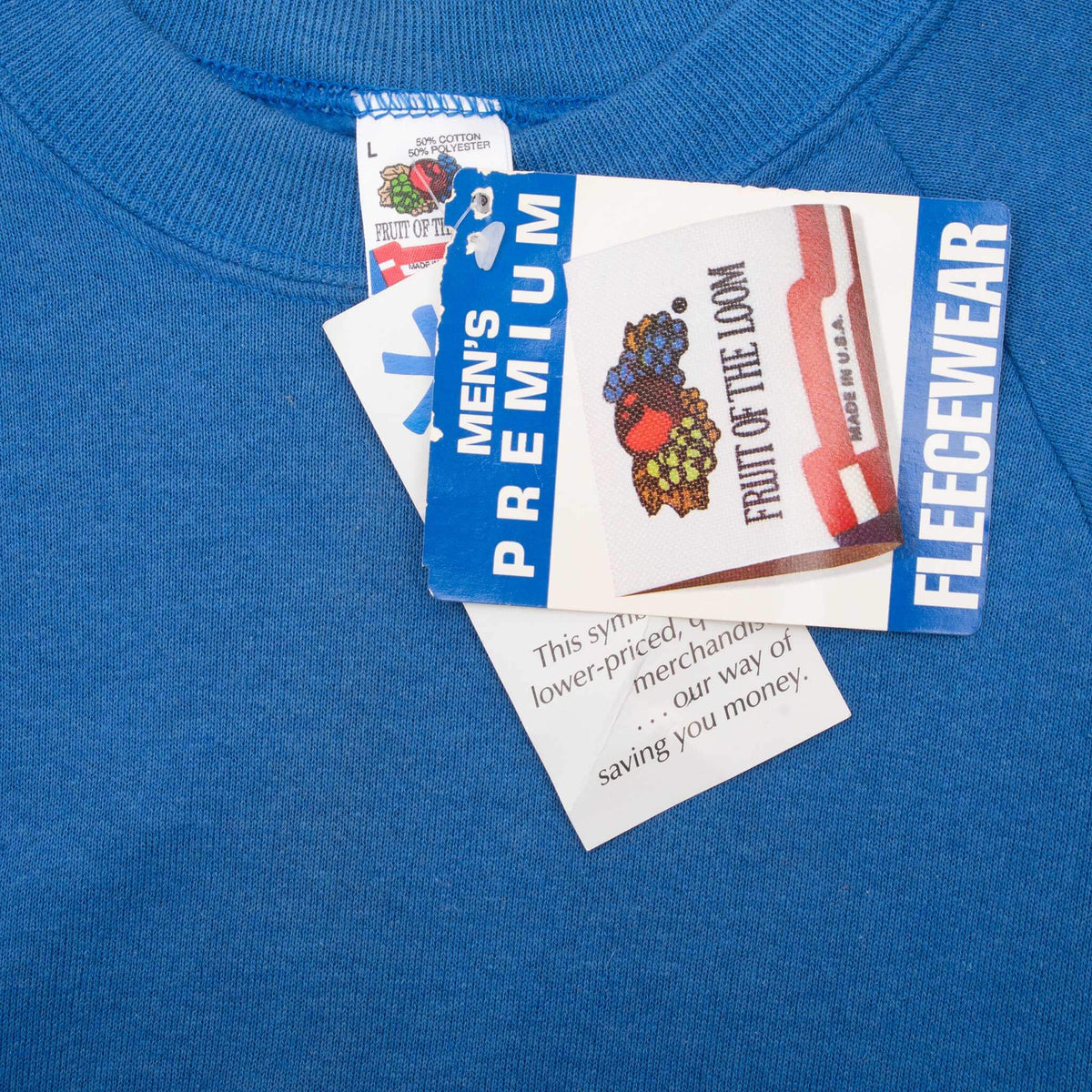 Fruit of the Loom neck label and retail tags on blue crewneck sweatshirt