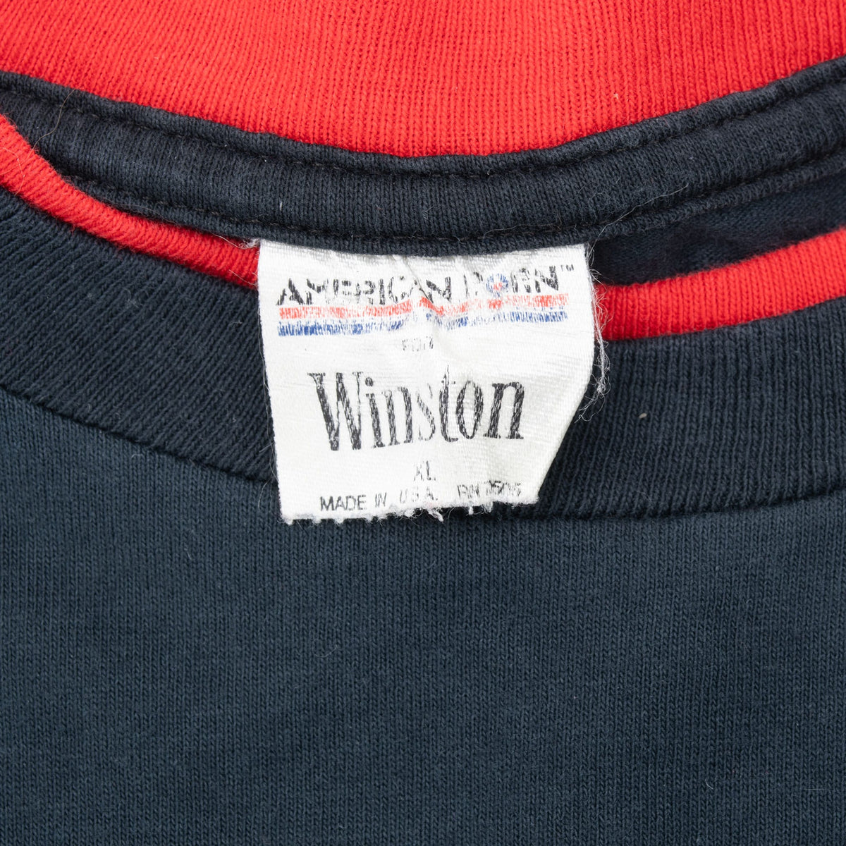Winston neck tag and red collar detail on black T-shirt