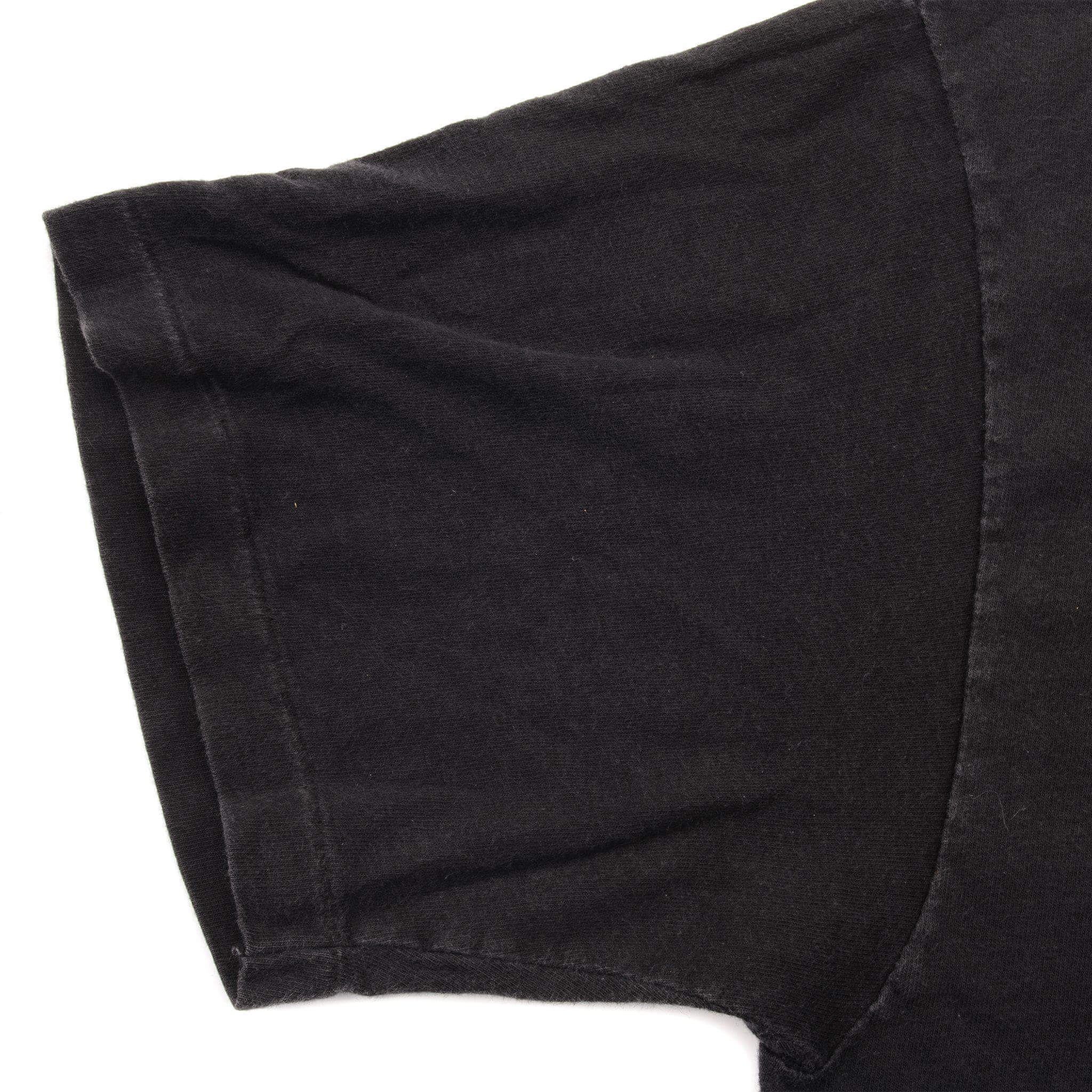 Close-up of black T-shirt sleeve and single-stitched hem