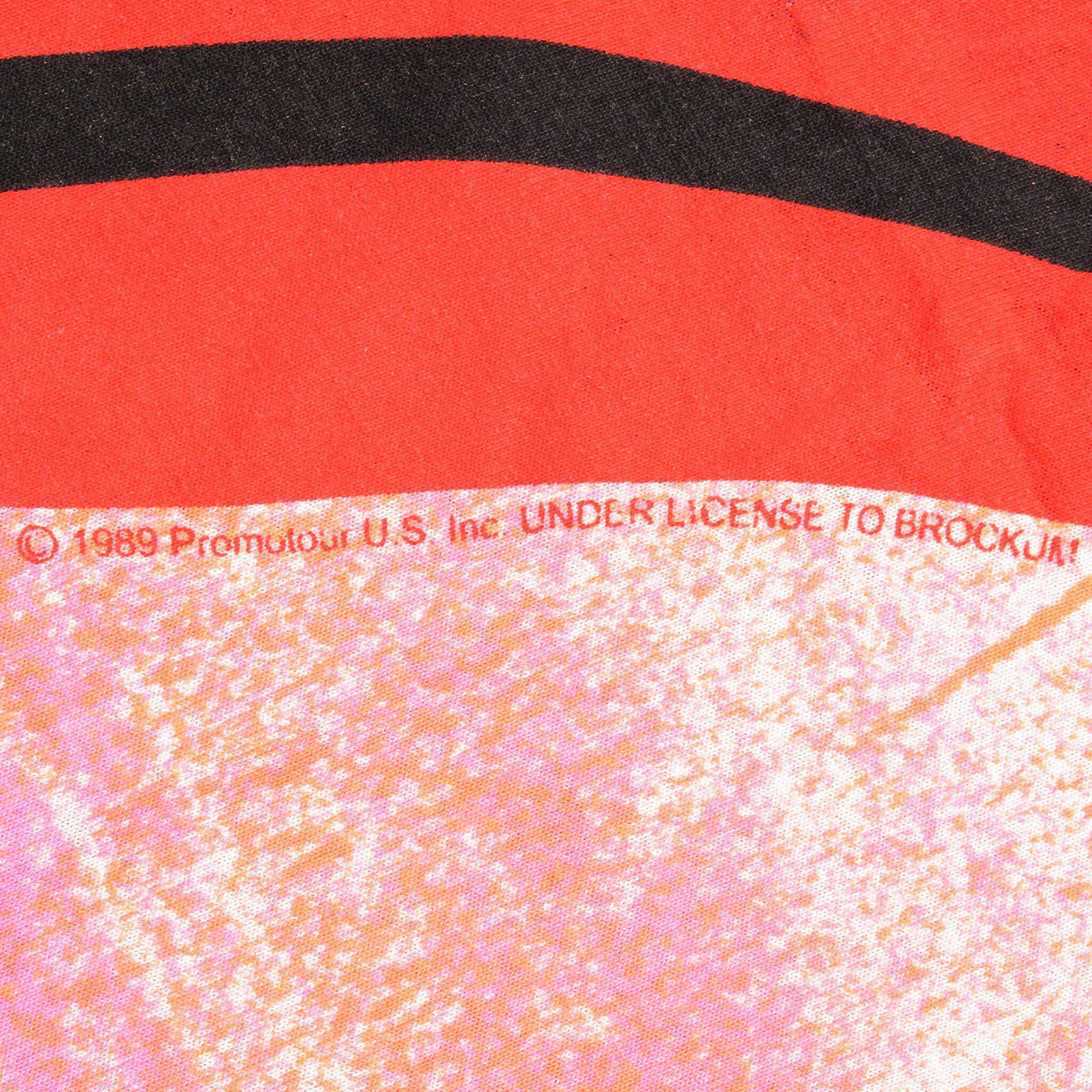 Close-up of 1989 Promotour licensing text beneath the red tongue print