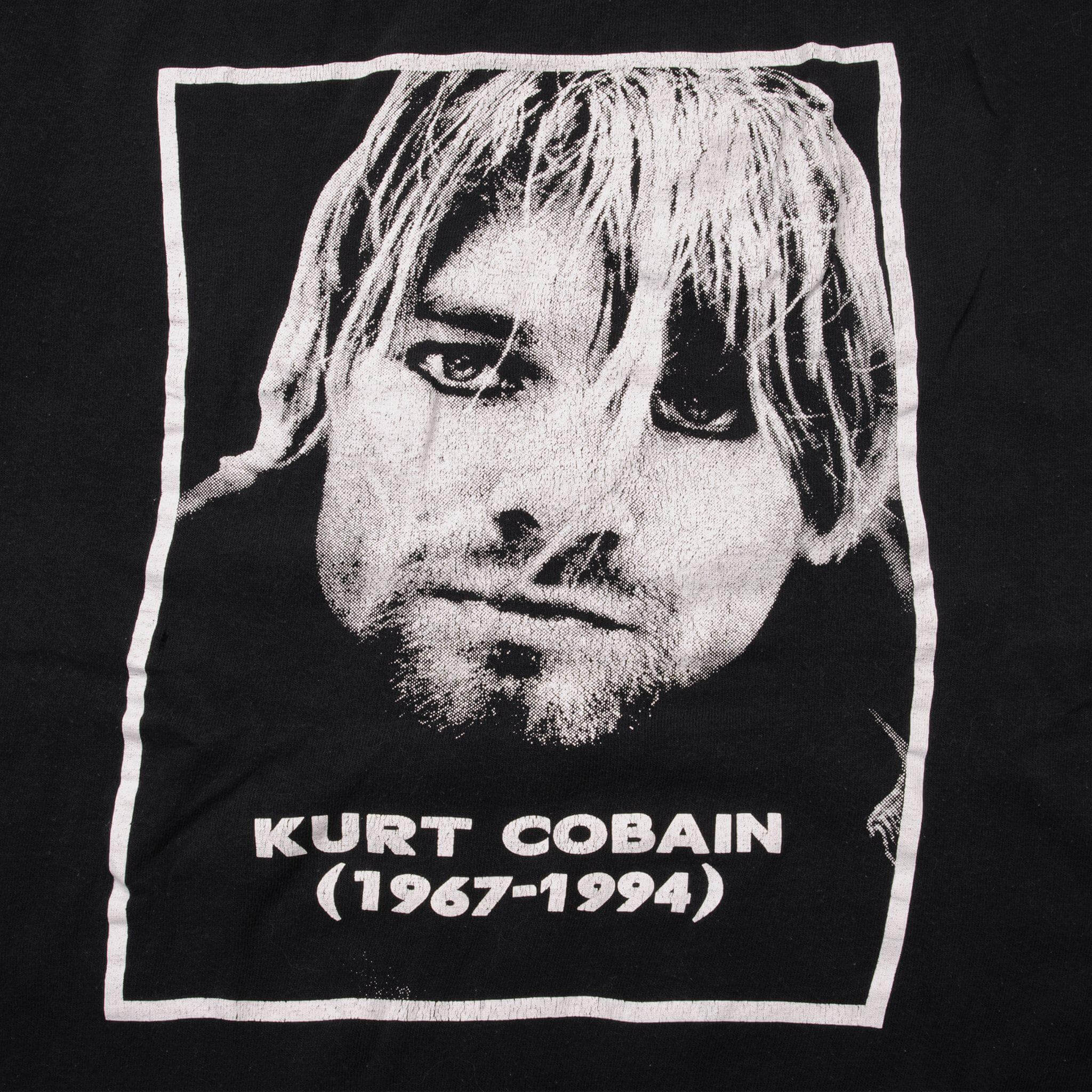 Close-up of Kurt Cobain portrait print with 1967–1994 text