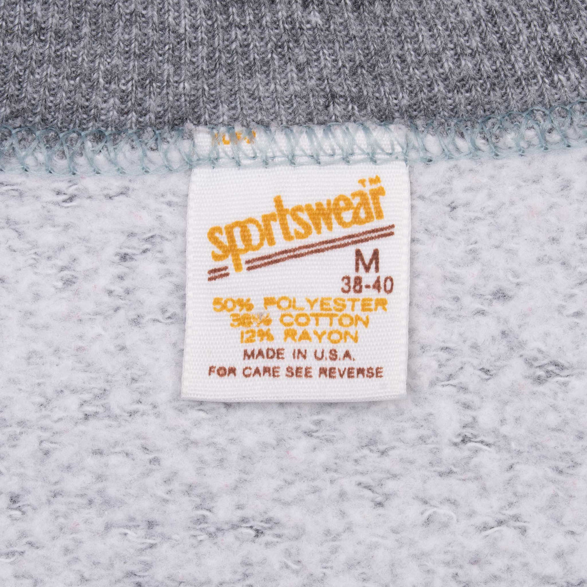 Sportswear medium tag showing tri-blend fabric content and Made in USA text