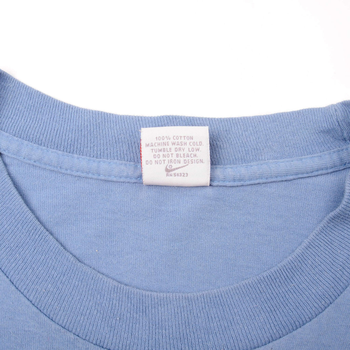 Close-up of care label inside the blue Nike T-shirt collar