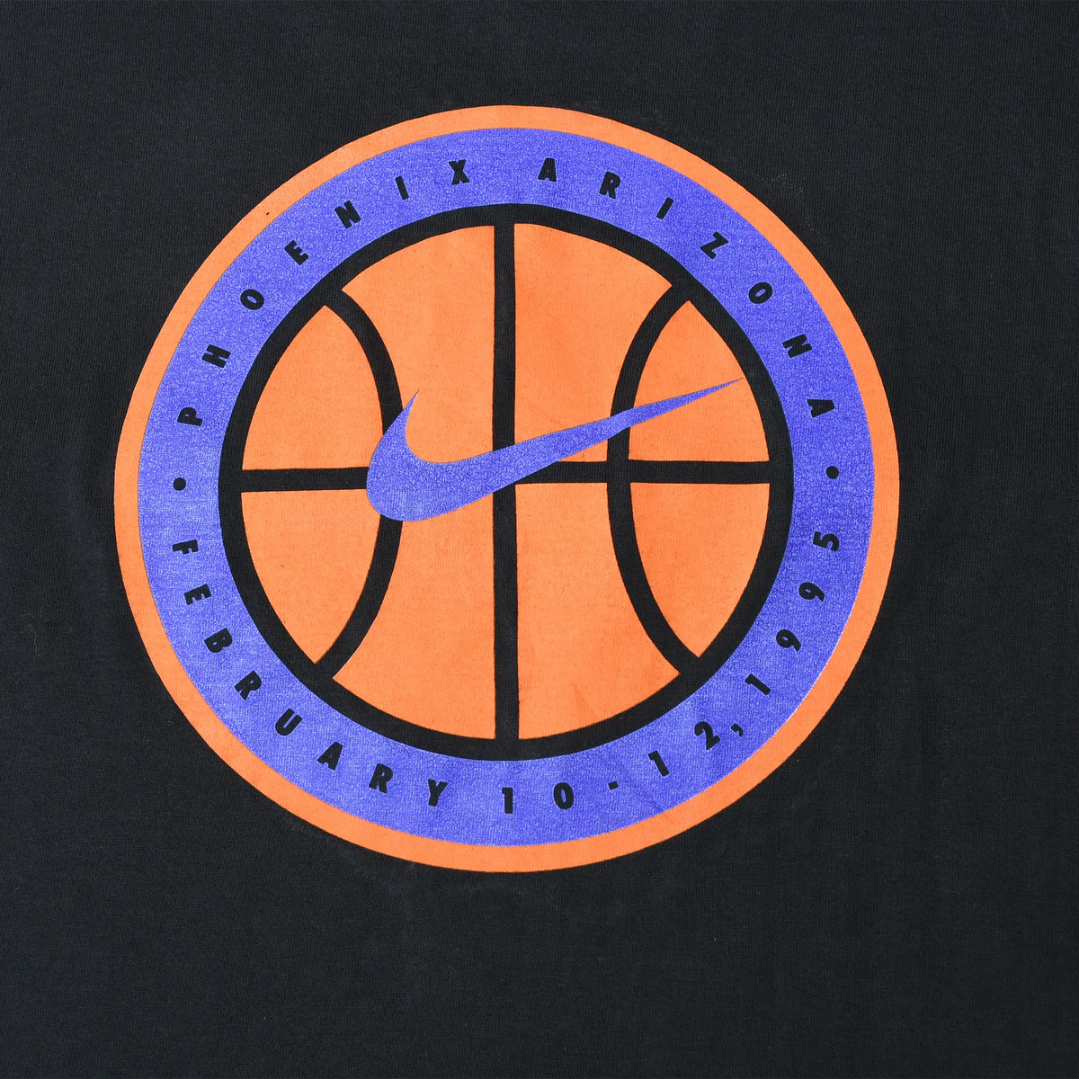 Close-up of orange and purple basketball back graphic reading Phoenix Arizona, February 10, 1995