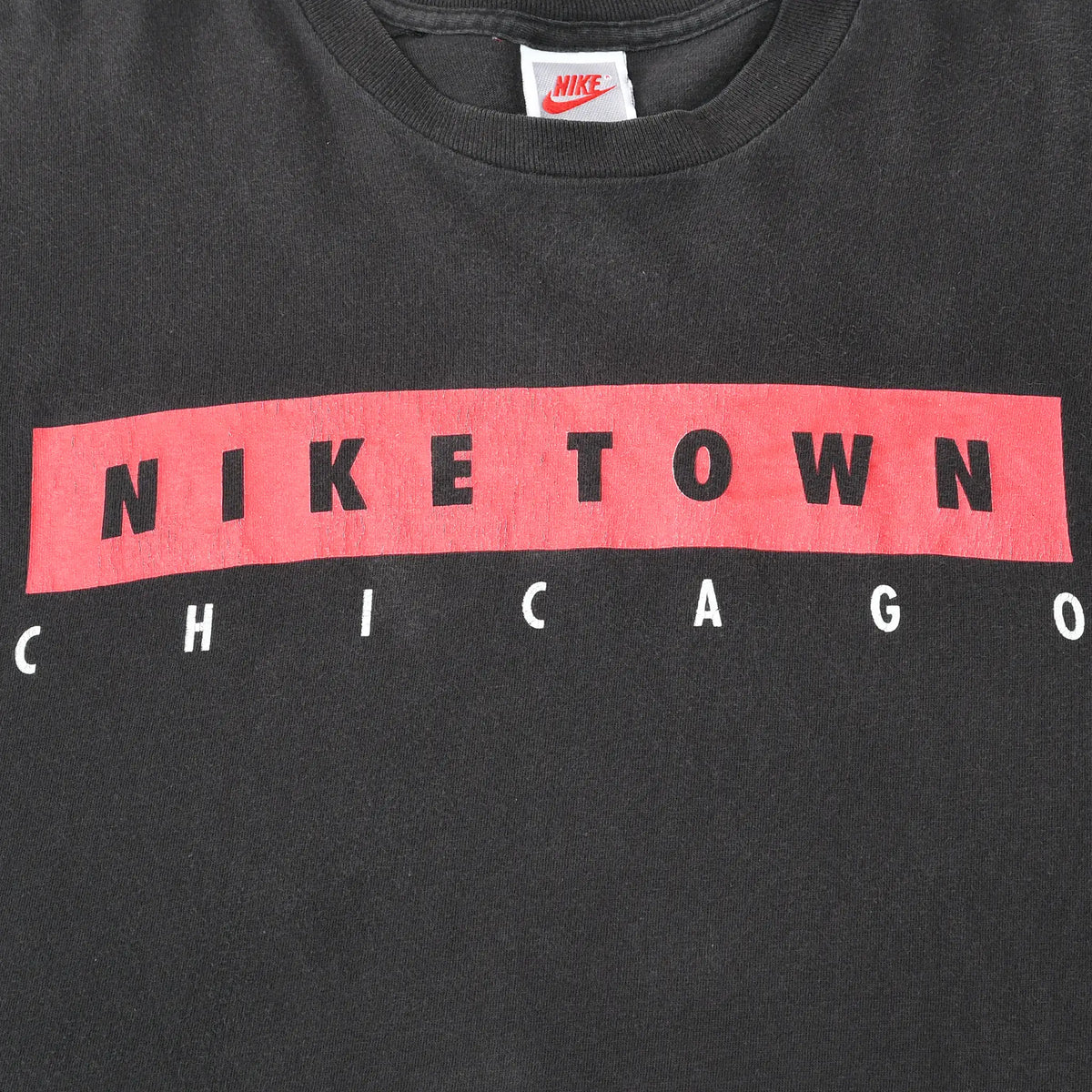 Close-up of red, black, and white Nike Town Chicago chest print
