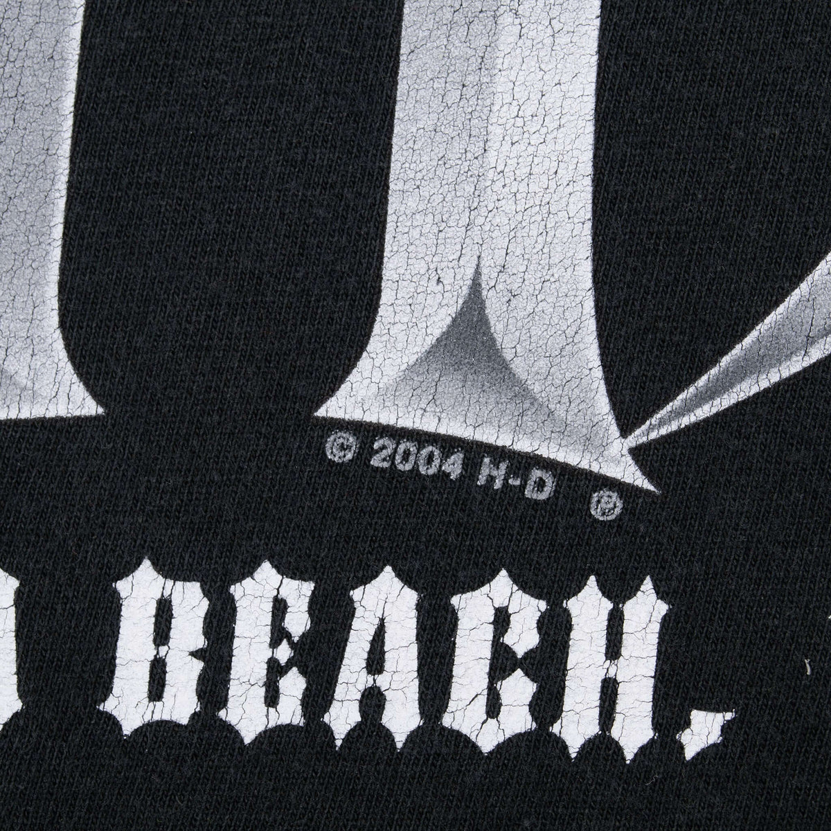 Close-up of 2004 H-D copyright mark and cracked back print