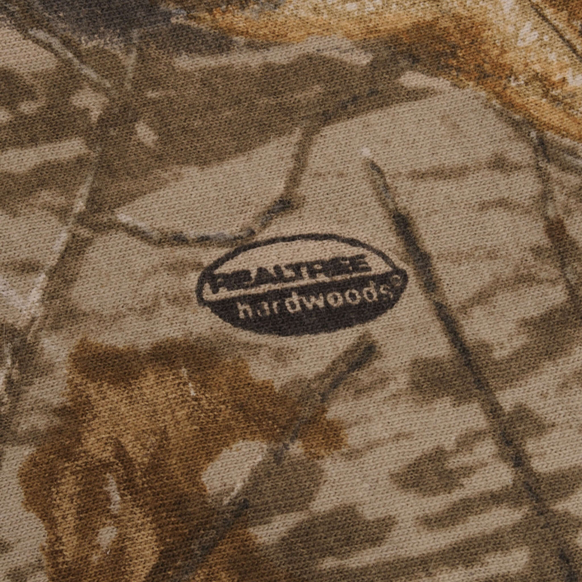 Realtree Hardwoods logo printed on camouflage fabric