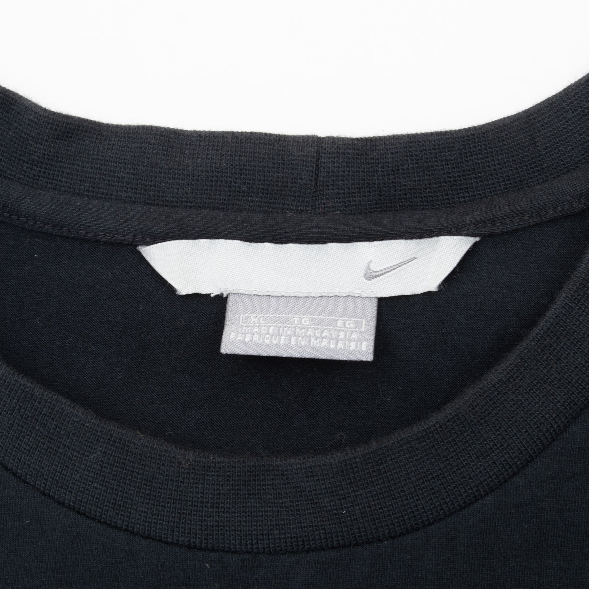Nike neck label and Swoosh tag inside black sleeveless shirt