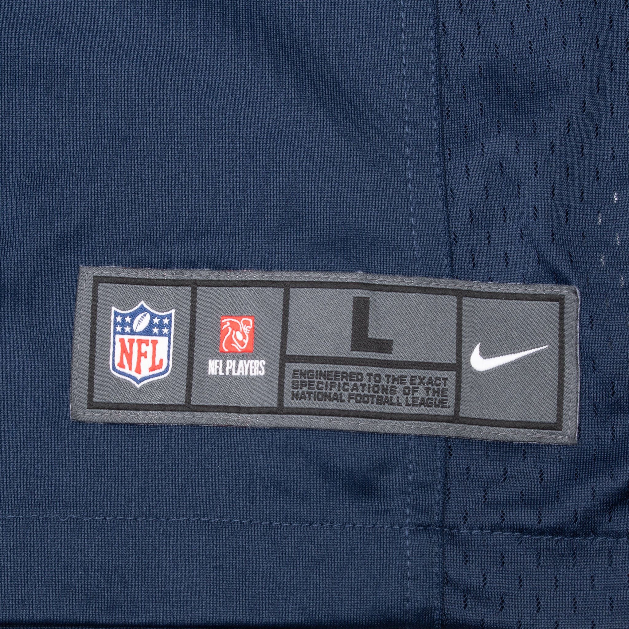 Nike NFL size large woven hem label on navy Cowboys jersey