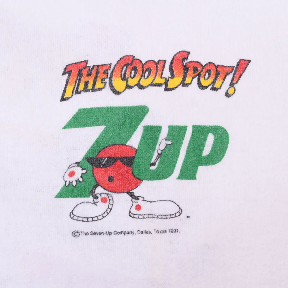 Close-up of chest print with The Cool Spot text, green 7UP logo, and character wearing sunglasses
