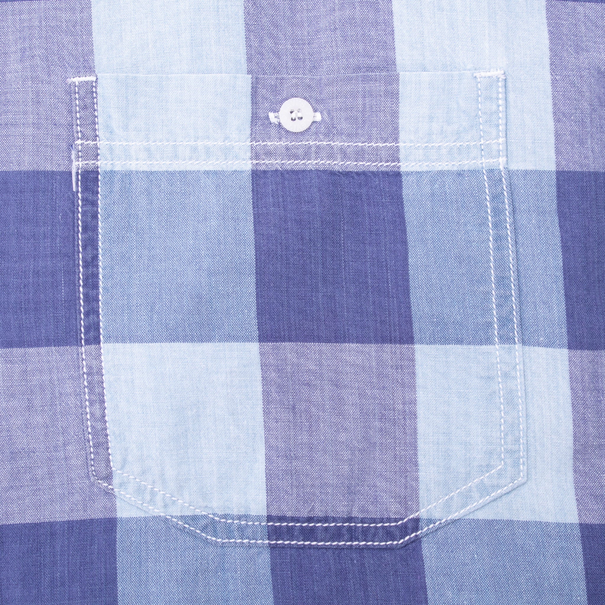 Close-up of buttoned chest pocket on blue large-check Levi's shirt