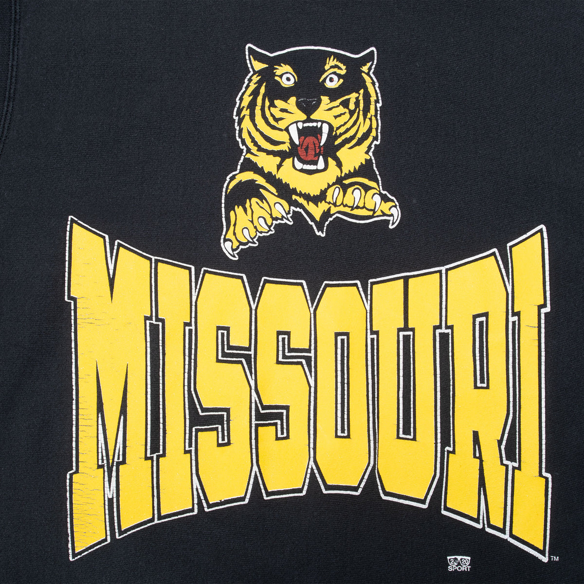 Close-up of yellow Missouri lettering and Tigers mascot graphic on black sweatshirt