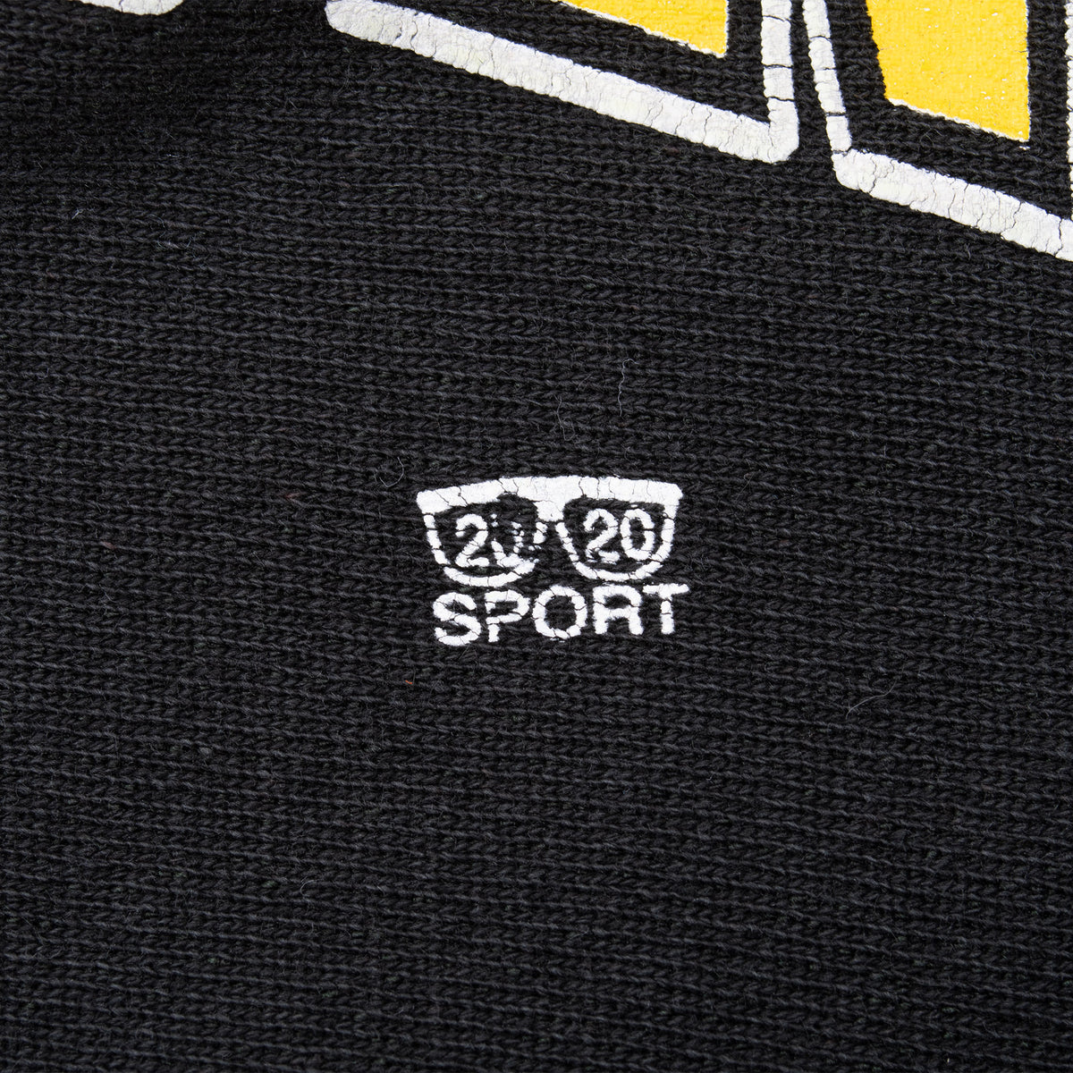 Close-up of white 20/20 Sport logo beneath the front graphic