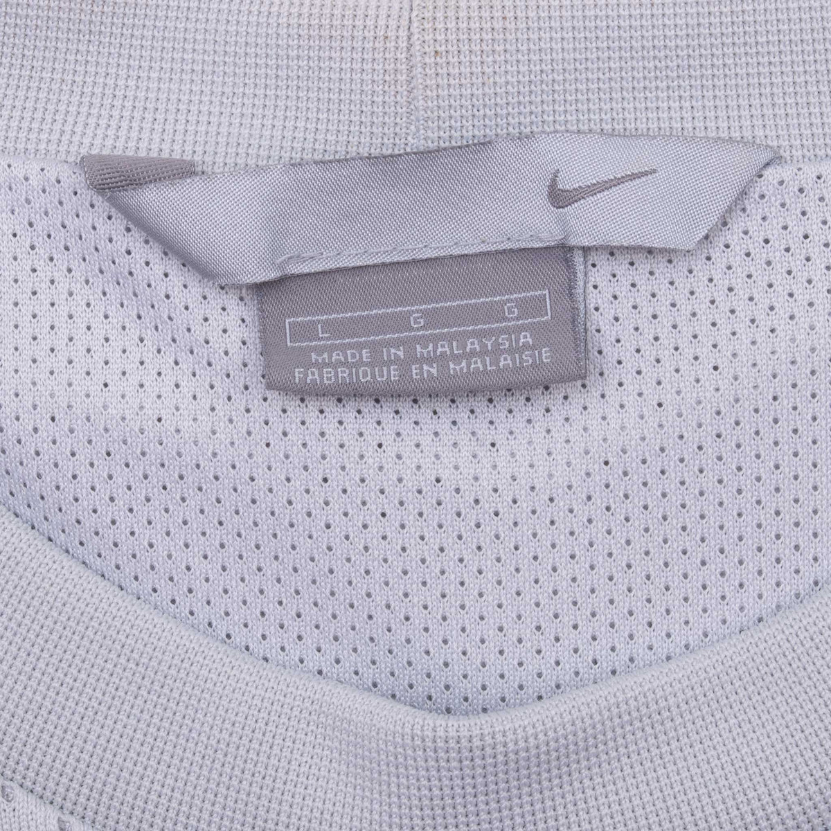 Nike neck and size label inside grey mesh basketball jersey