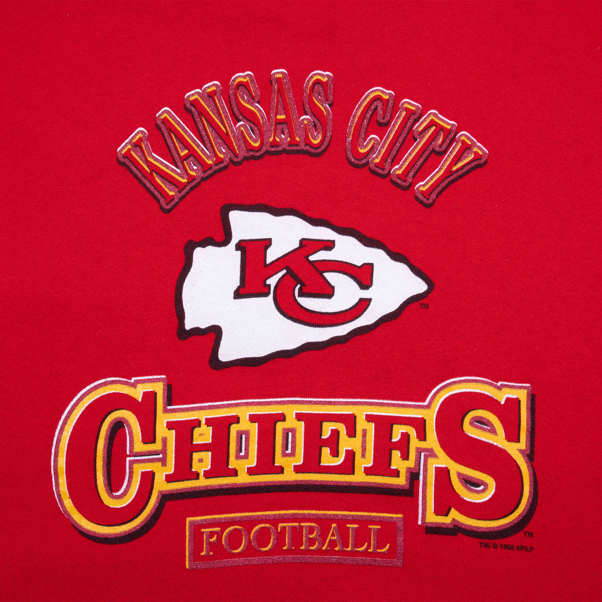 Close-up of Kansas City Chiefs Football graphic and arrowhead logo on red sweatshirt