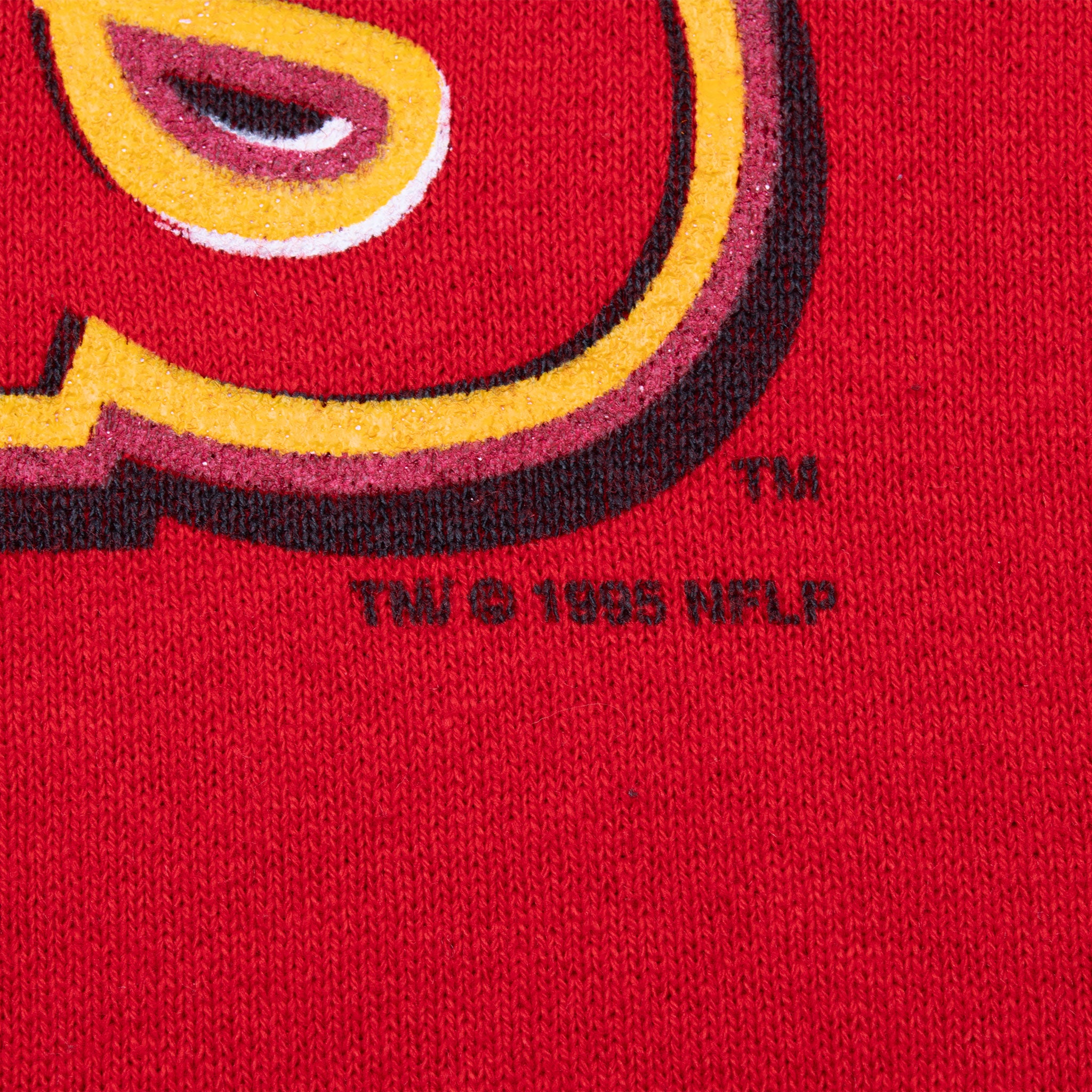 Close-up of 1995 NFLP copyright mark beneath the Chiefs graphic