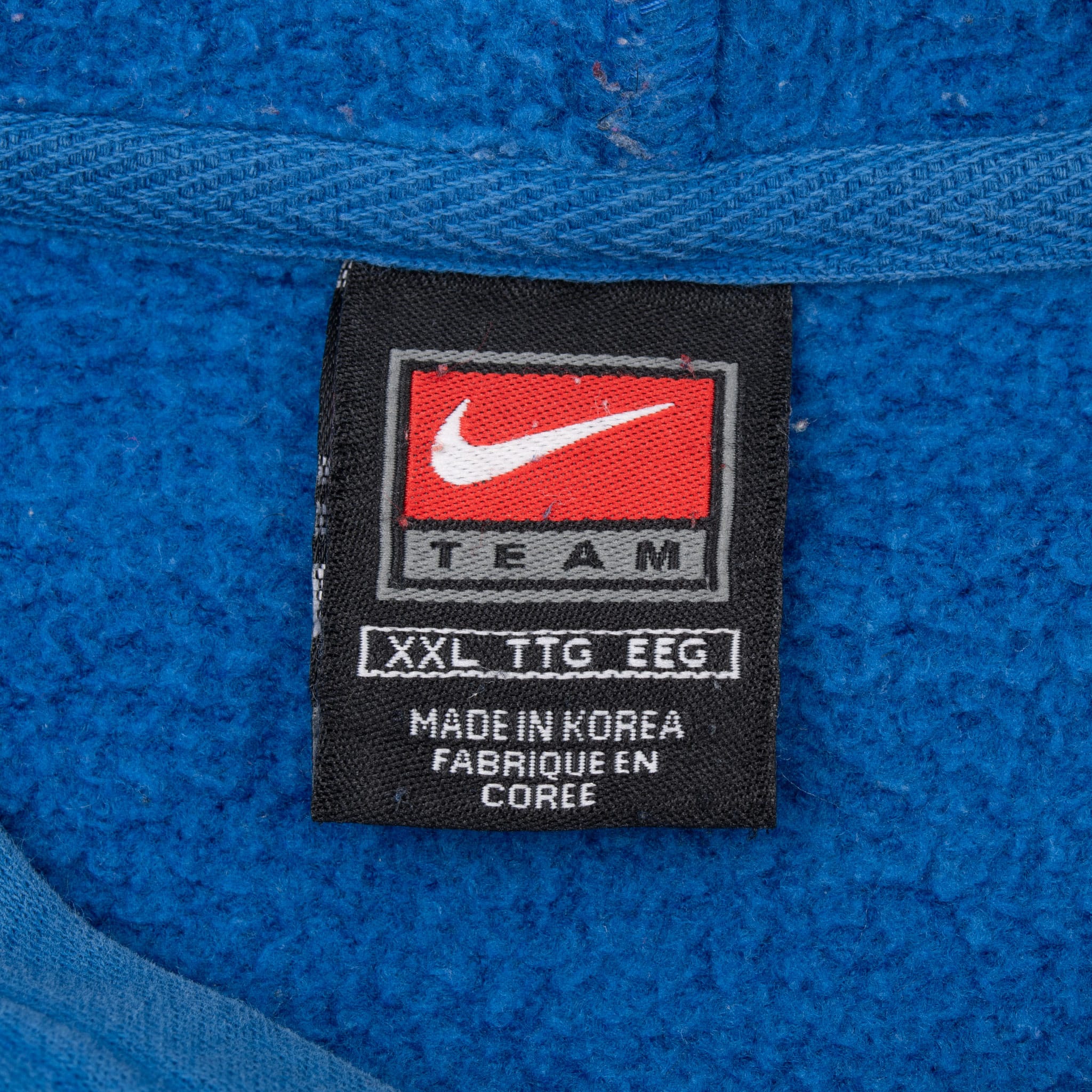Nike Team neck label on blue hoodie marked XXL and made in Korea
