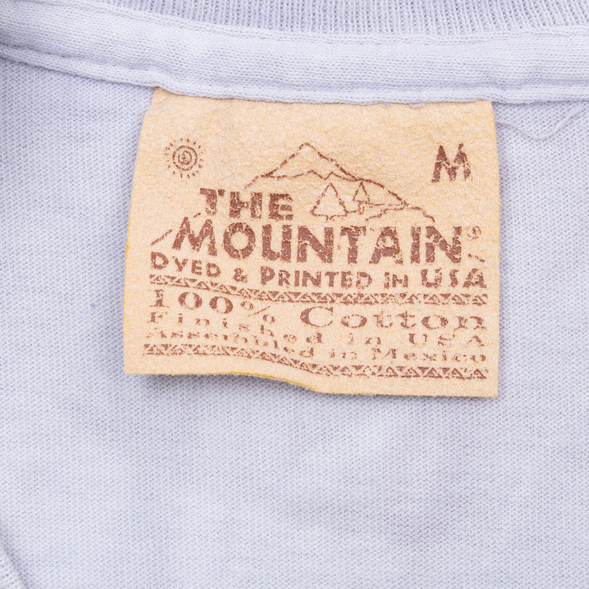 The Mountain neck tag marked M and 100% cotton