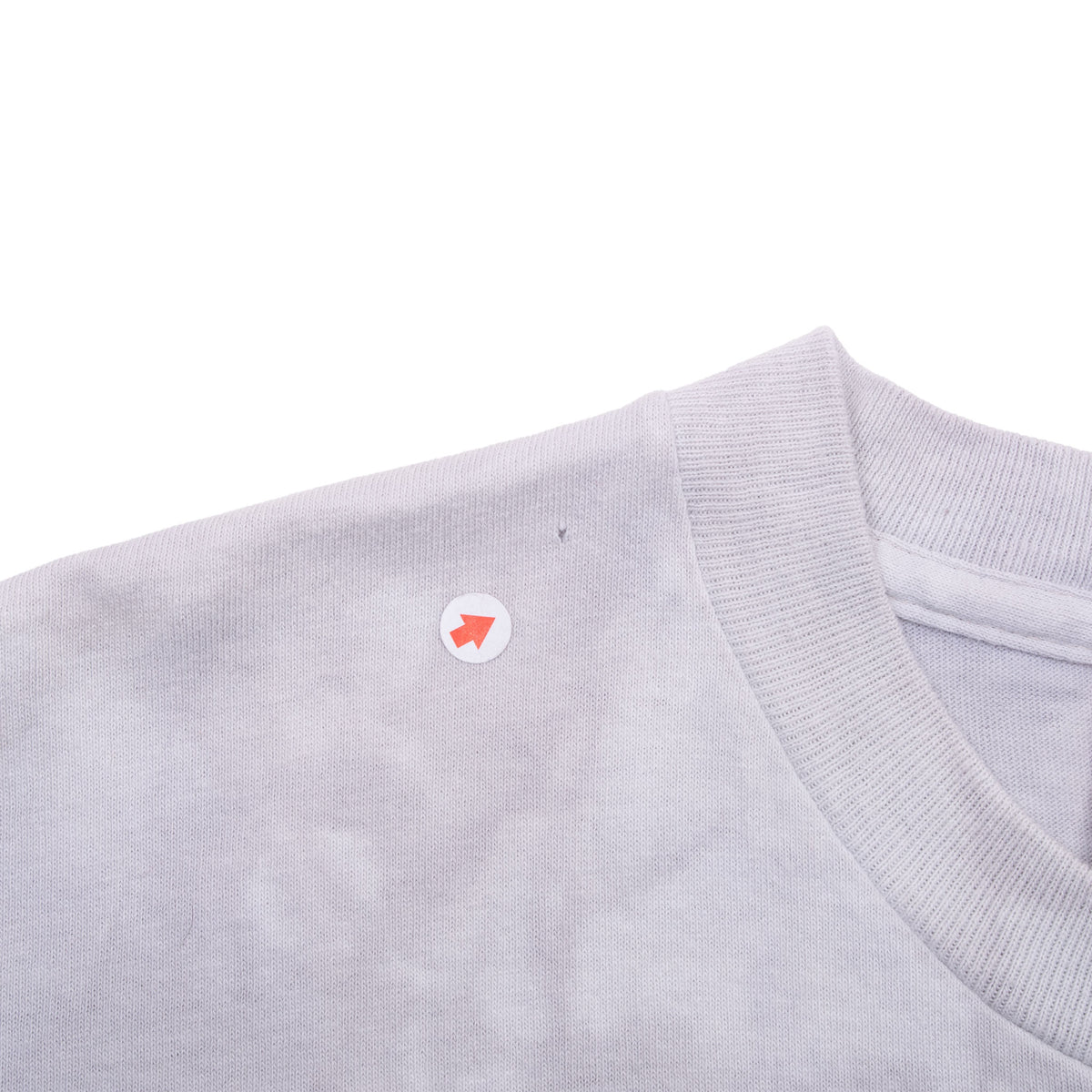 Close-up of collar and shoulder with arrow marking a small spot