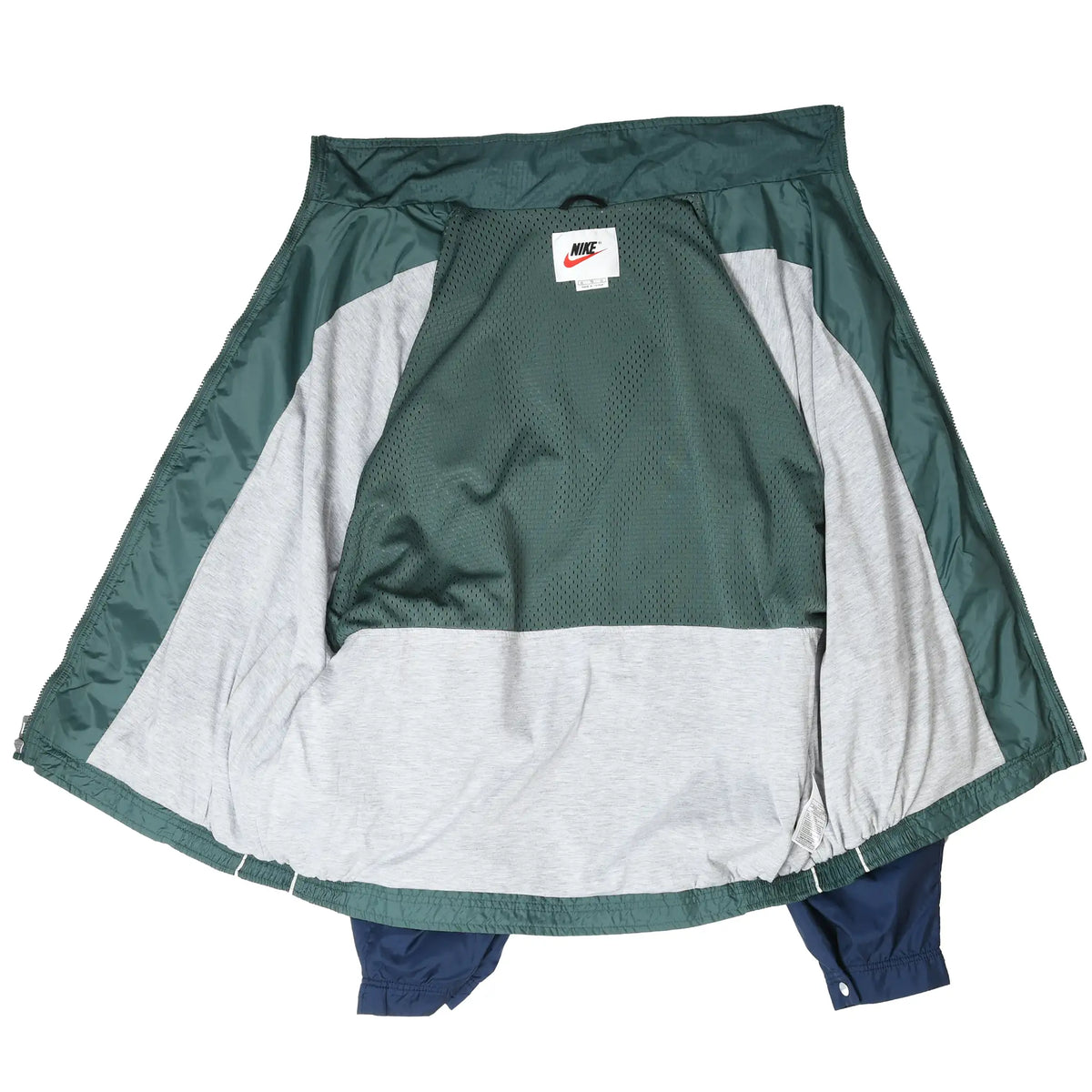 Open Nike windbreaker showing green mesh and light gray interior lining