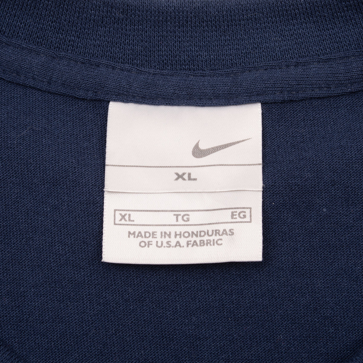Nike neck tag marked XL inside navy tank top
