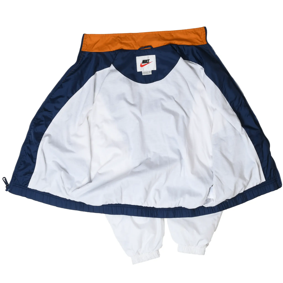 Open Nike windbreaker showing white interior lining, navy trim, orange collar, and neck label