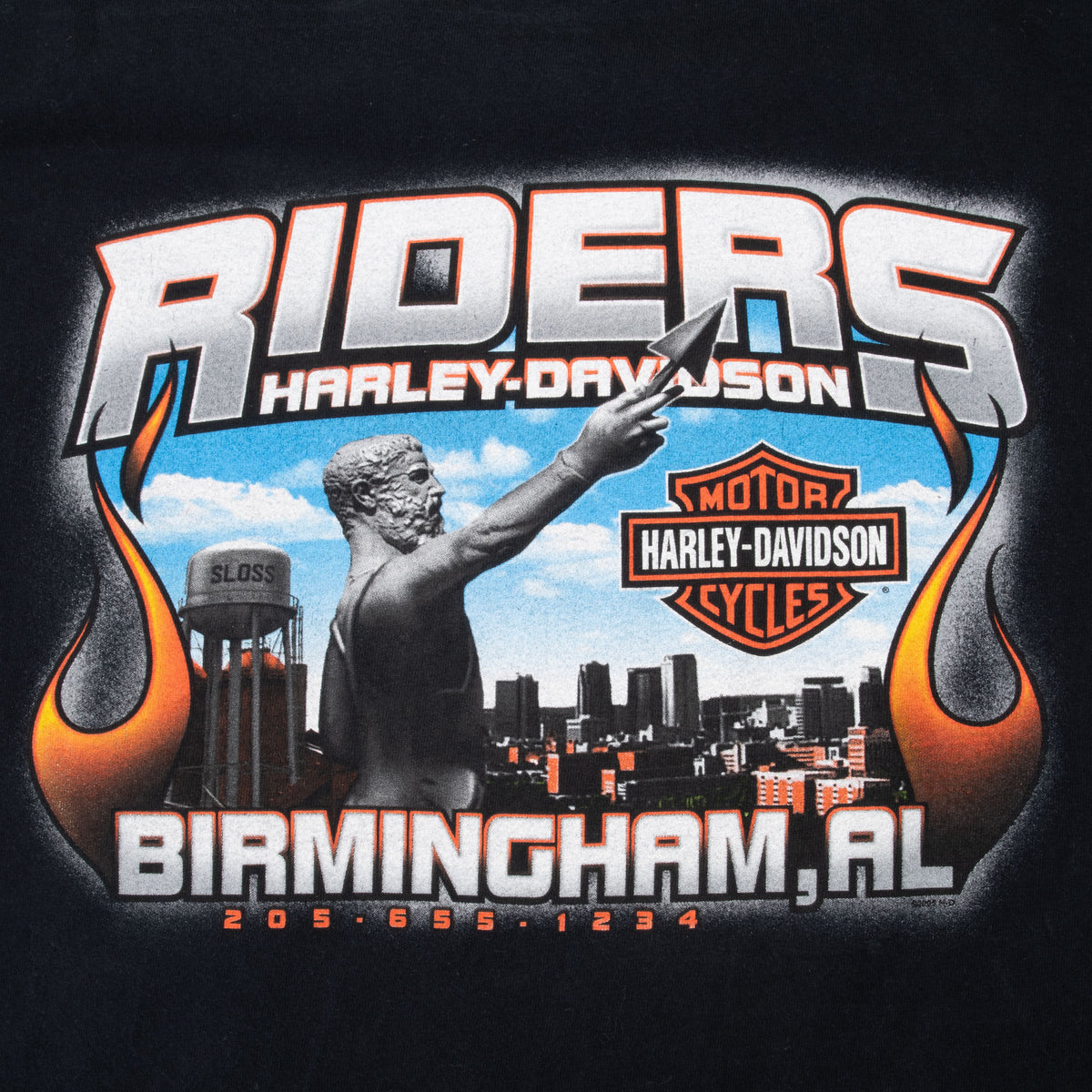 Close-up of Riders Harley-Davidson Birmingham, AL back graphic with statue, skyline, and flames