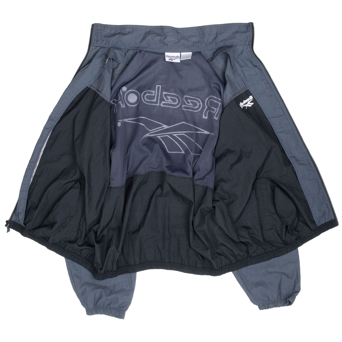Reebok windbreaker opened to show black mesh lining and interior back logo