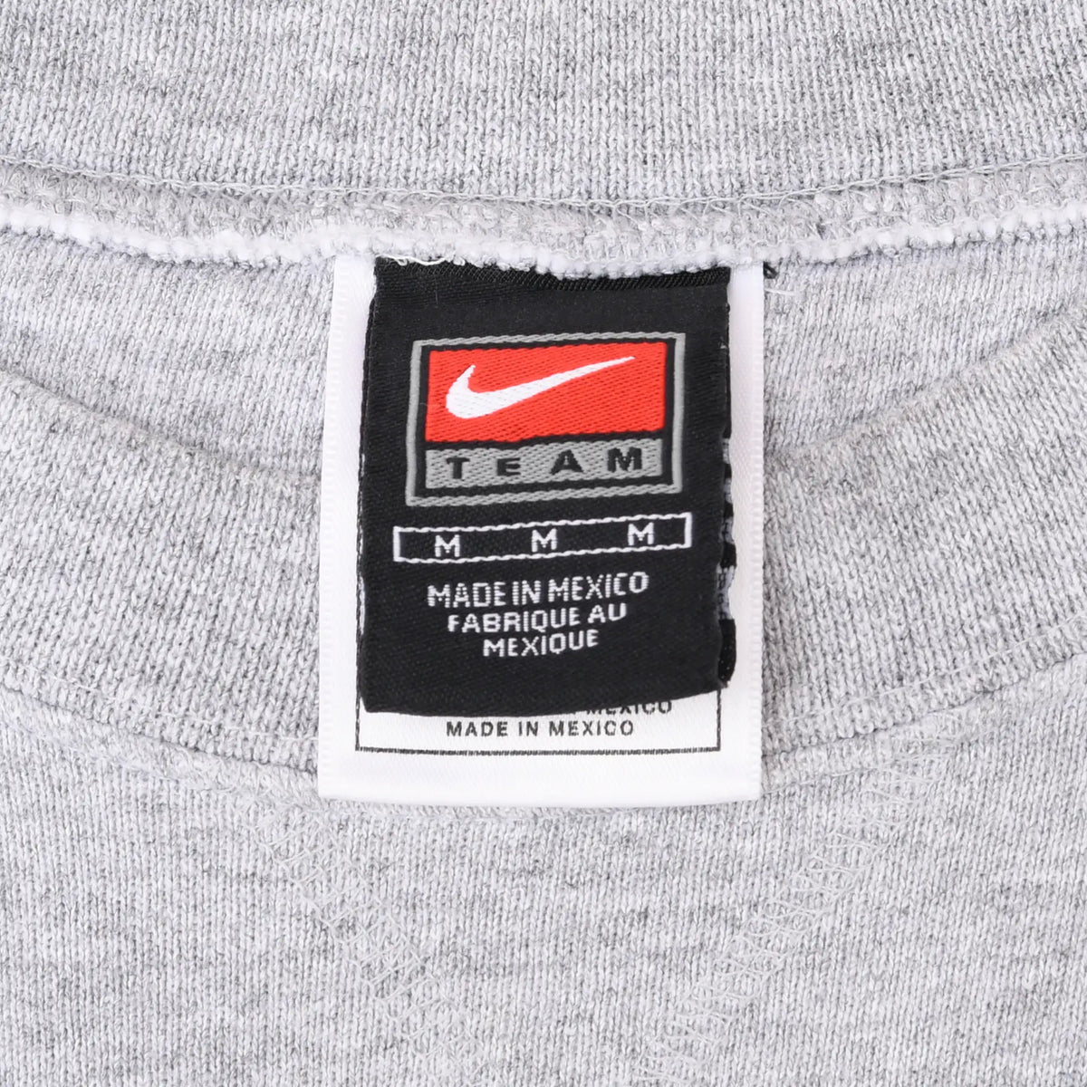 Close-up of Nike Team medium neck label inside grey sweatshirt