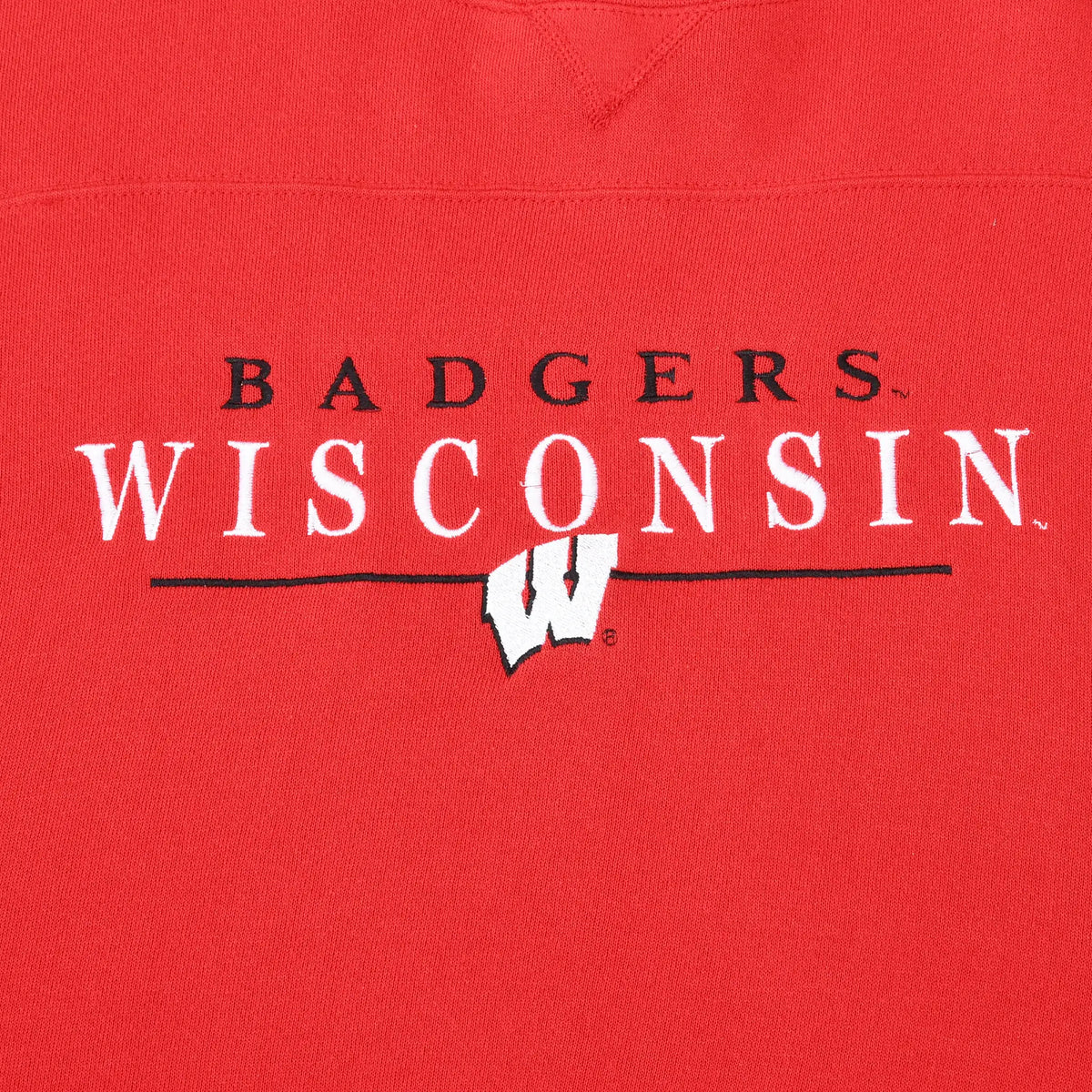 Close-up of embroidered Badgers Wisconsin lettering and W logo on red sweatshirt