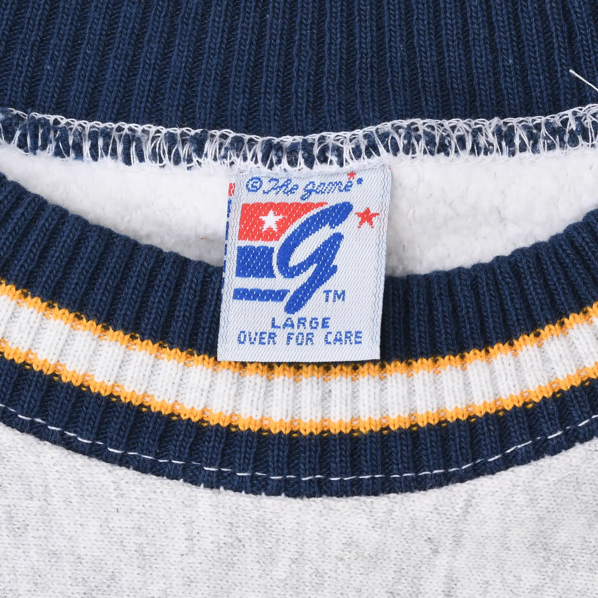 Close-up of Great Games large tag inside the navy, white, and maize striped collar