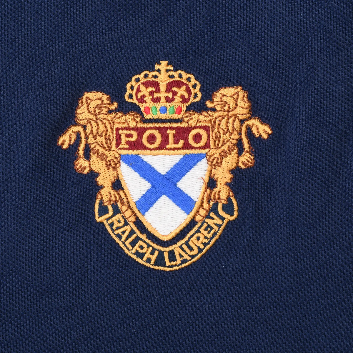 Close-up of multicolor Polo Ralph Lauren crest embroidery on navy fabric