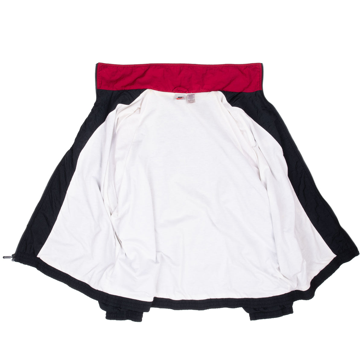 Nike windbreaker opened to show white interior lining and red inner collar
