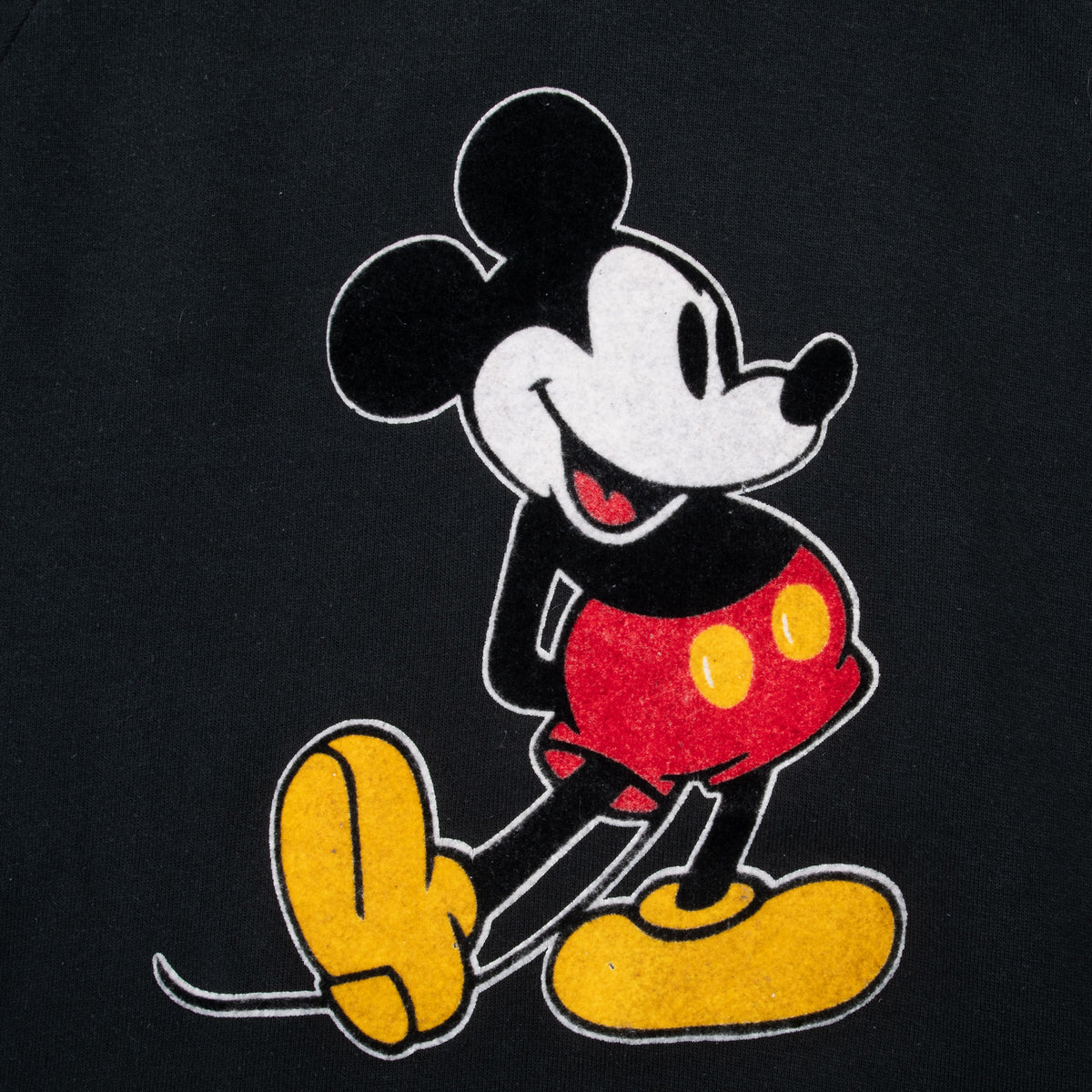 Close-up of velvet Mickey Mouse graphic in red, yellow, white, and black