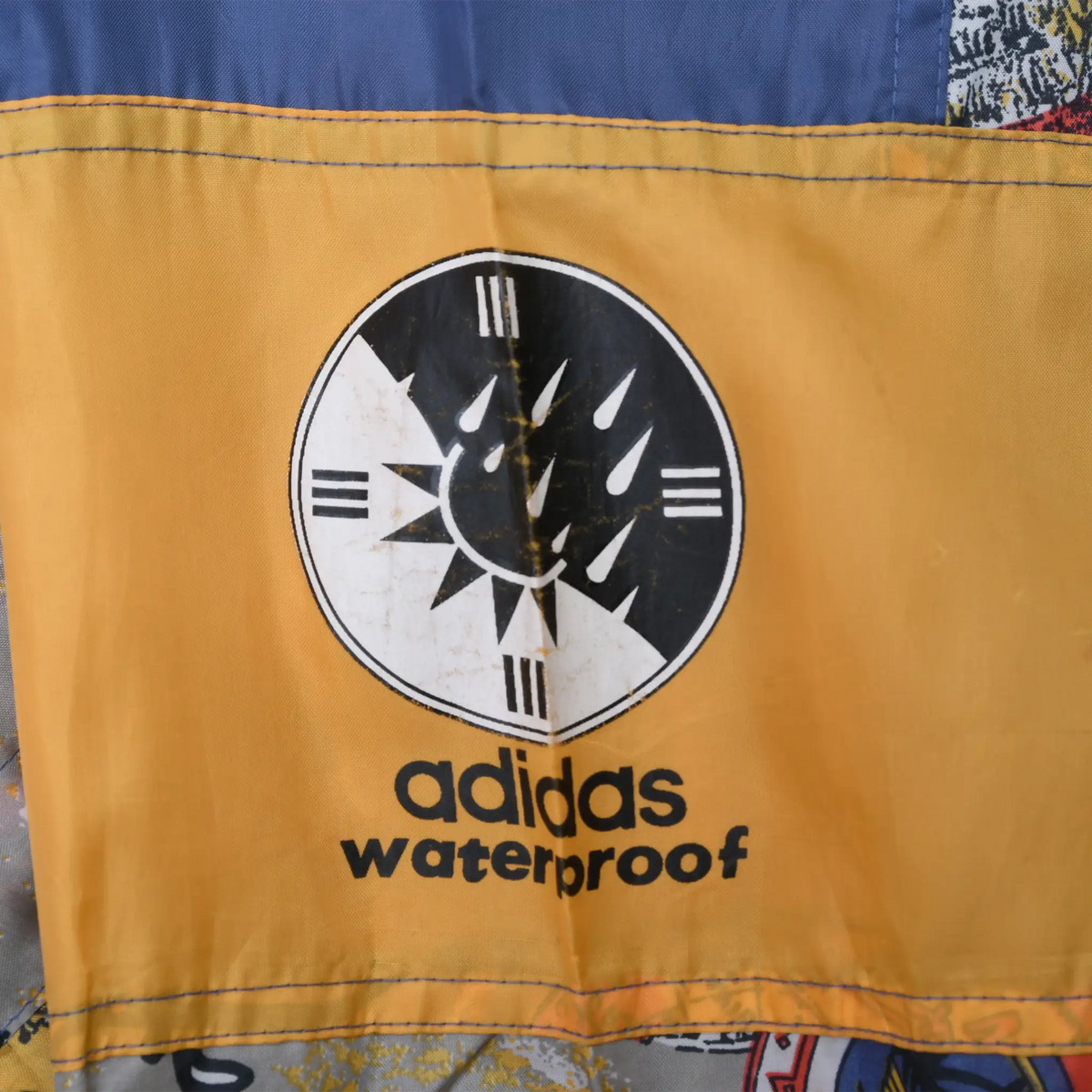 Adidas waterproof graphic printed on a yellow sleeve panel