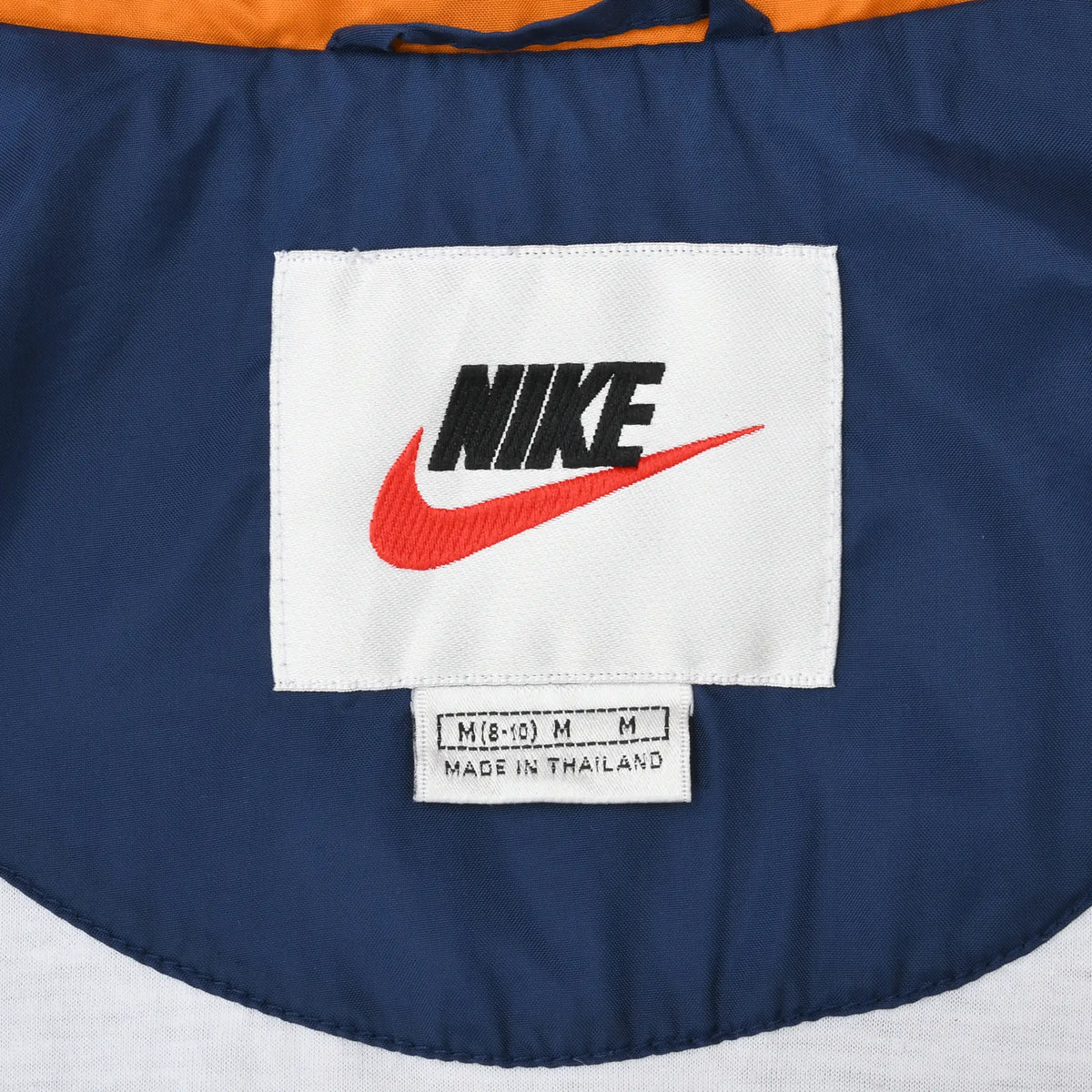 Nike neck label and size tag inside navy blue windbreaker jacket