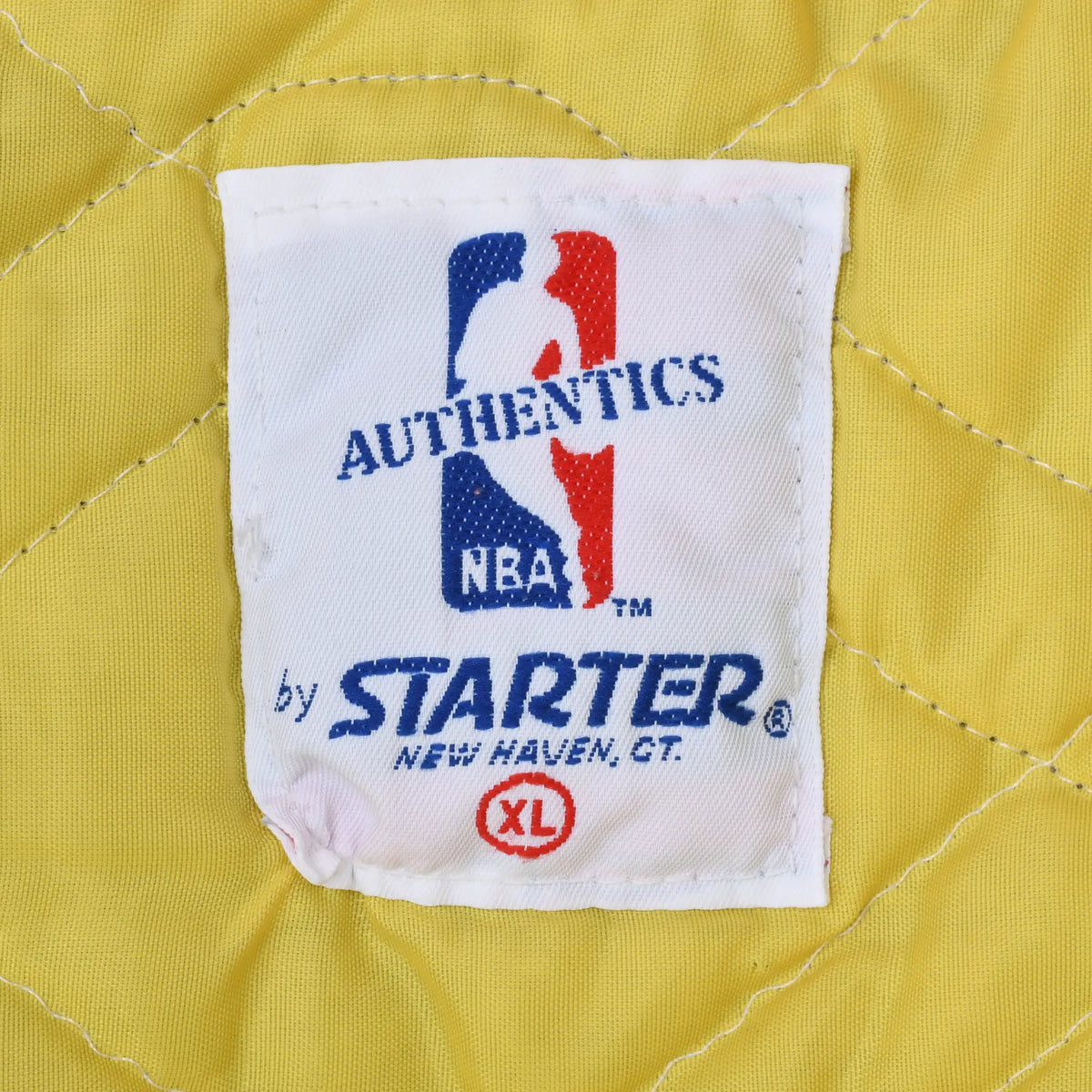 NBA by Starter XL neck label on yellow quilted jacket lining