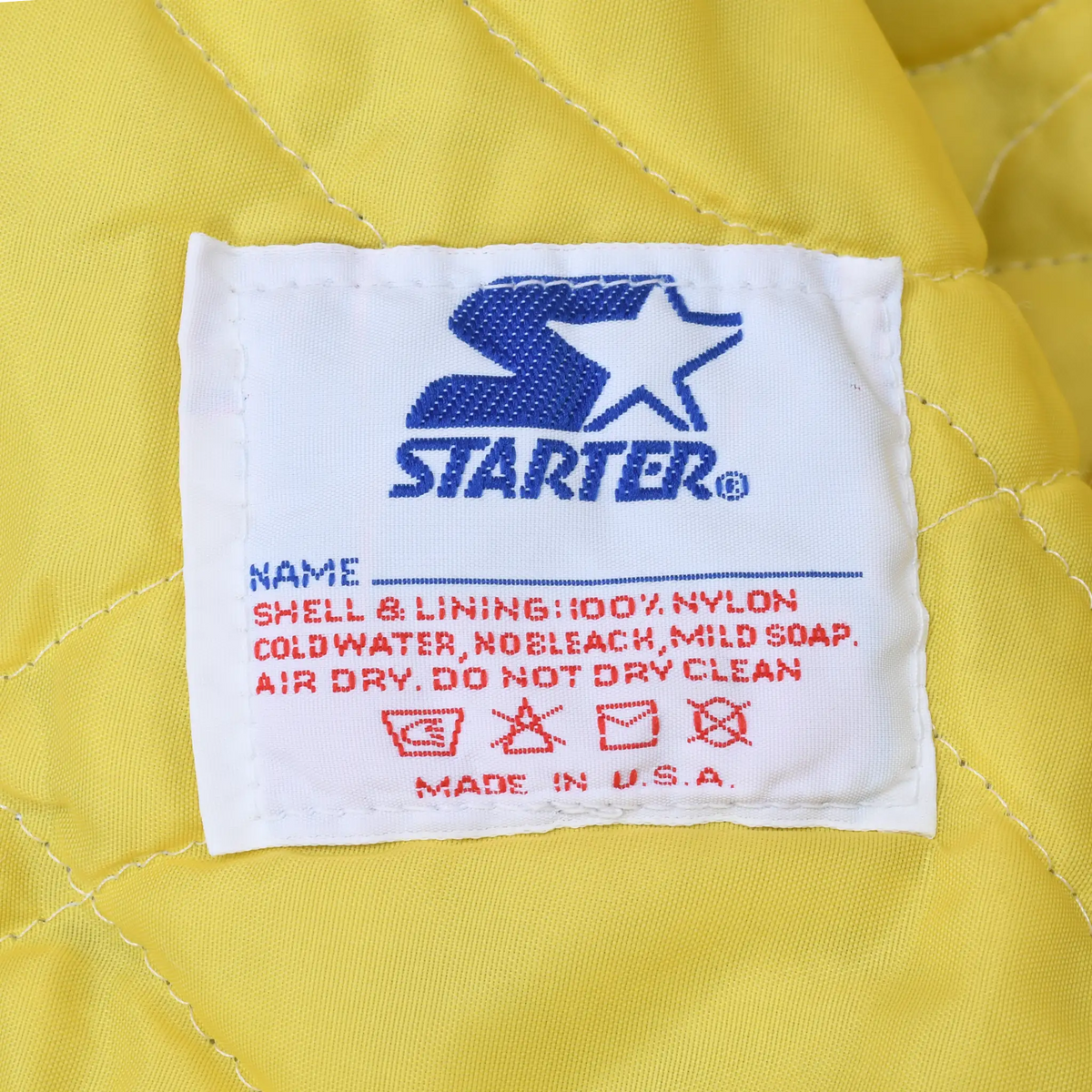Starter care label with nylon shell and lining details on yellow quilted lining