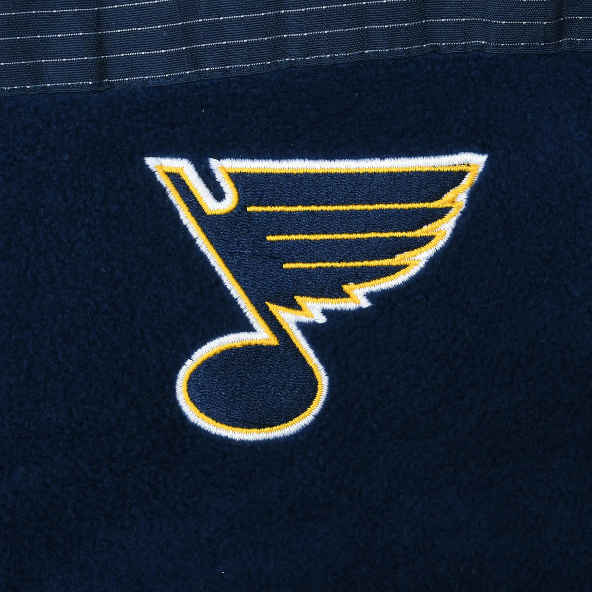Close-up of embroidered St. Louis Blues logo on navy fleece