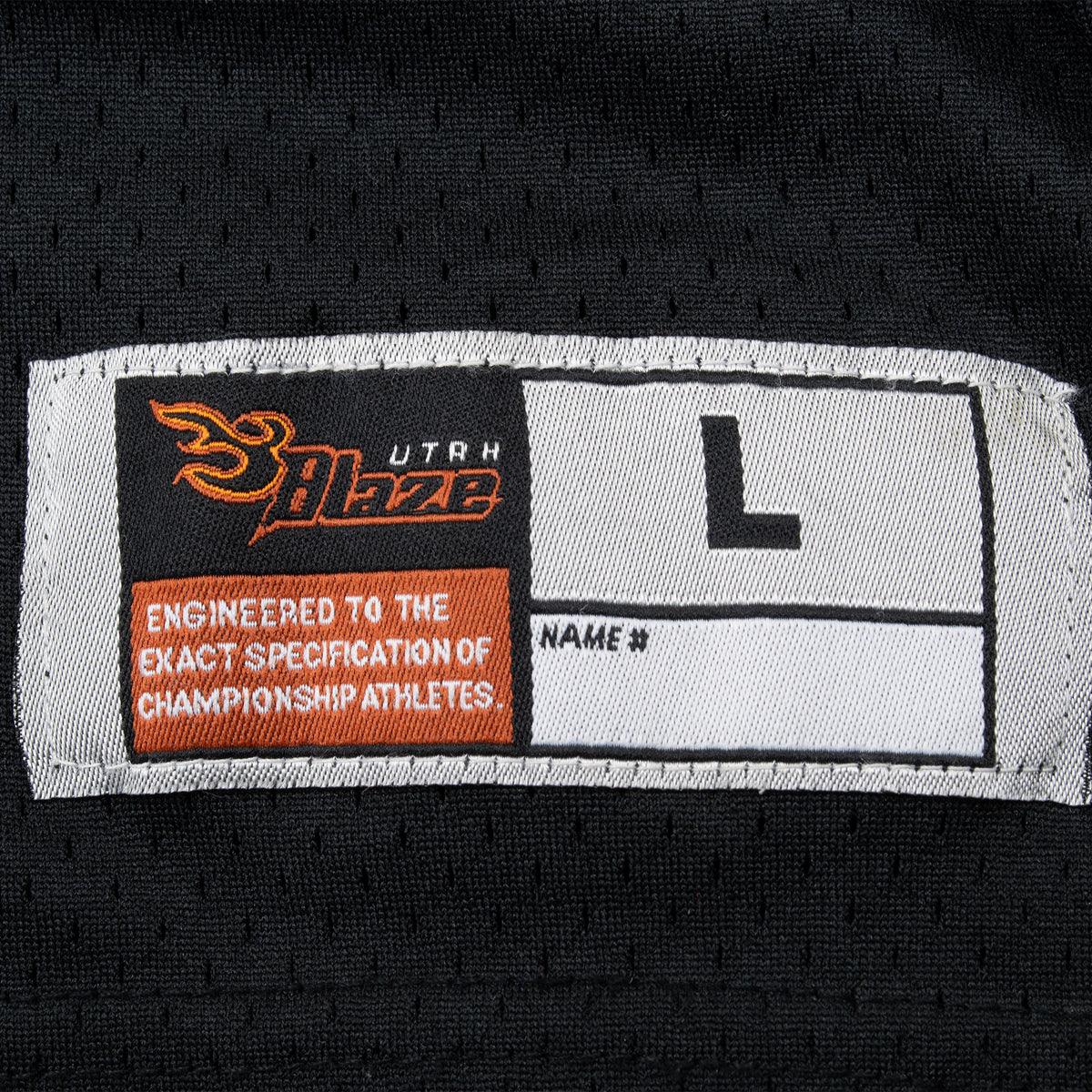 Utah Blaze size L woven hem label on black jersey fabric