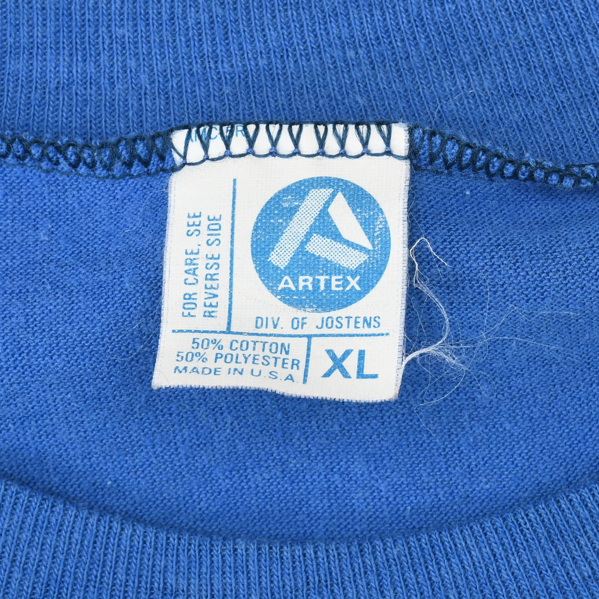 Close-up of Artex neck tag marked XL, 50% cotton, 50% polyester and made in USA