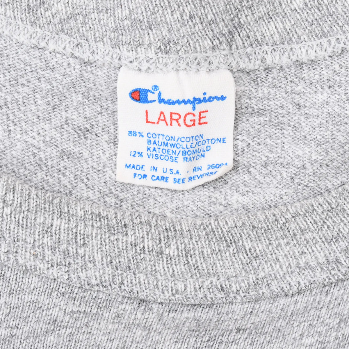 Close-up of the Champion Large neck tag and collar stitching on the gray T-shirt