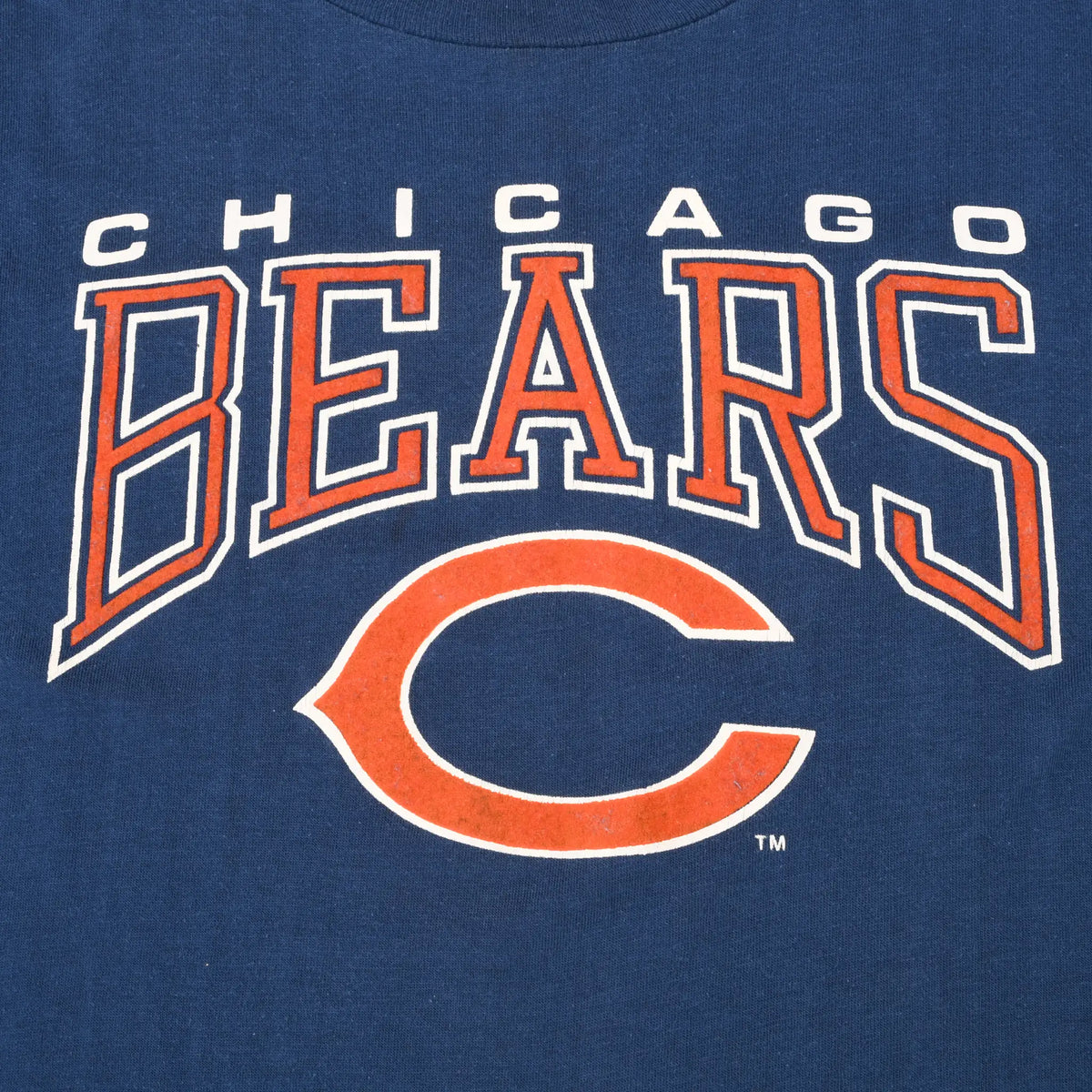 Close-up of orange and white Chicago Bears lettering and C logo on navy fabric
