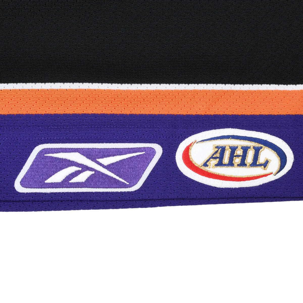 Close-up of Reebok and AHL logo patches on purple jersey hem