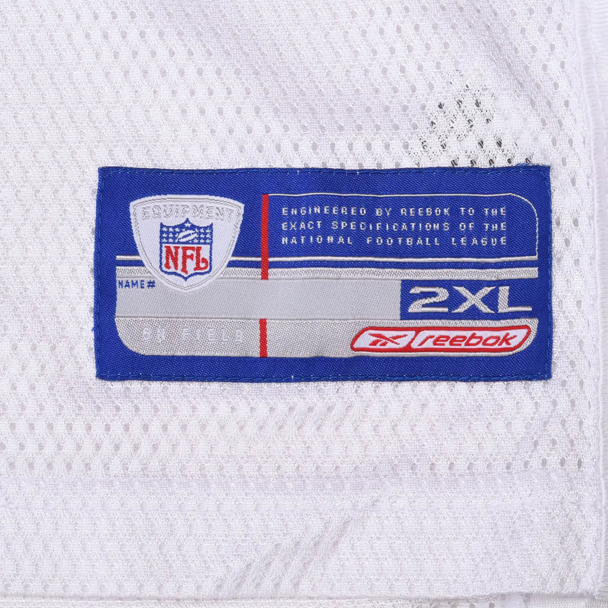 Close-up of Reebok NFL Equipment 2XL jock tag on white mesh jersey