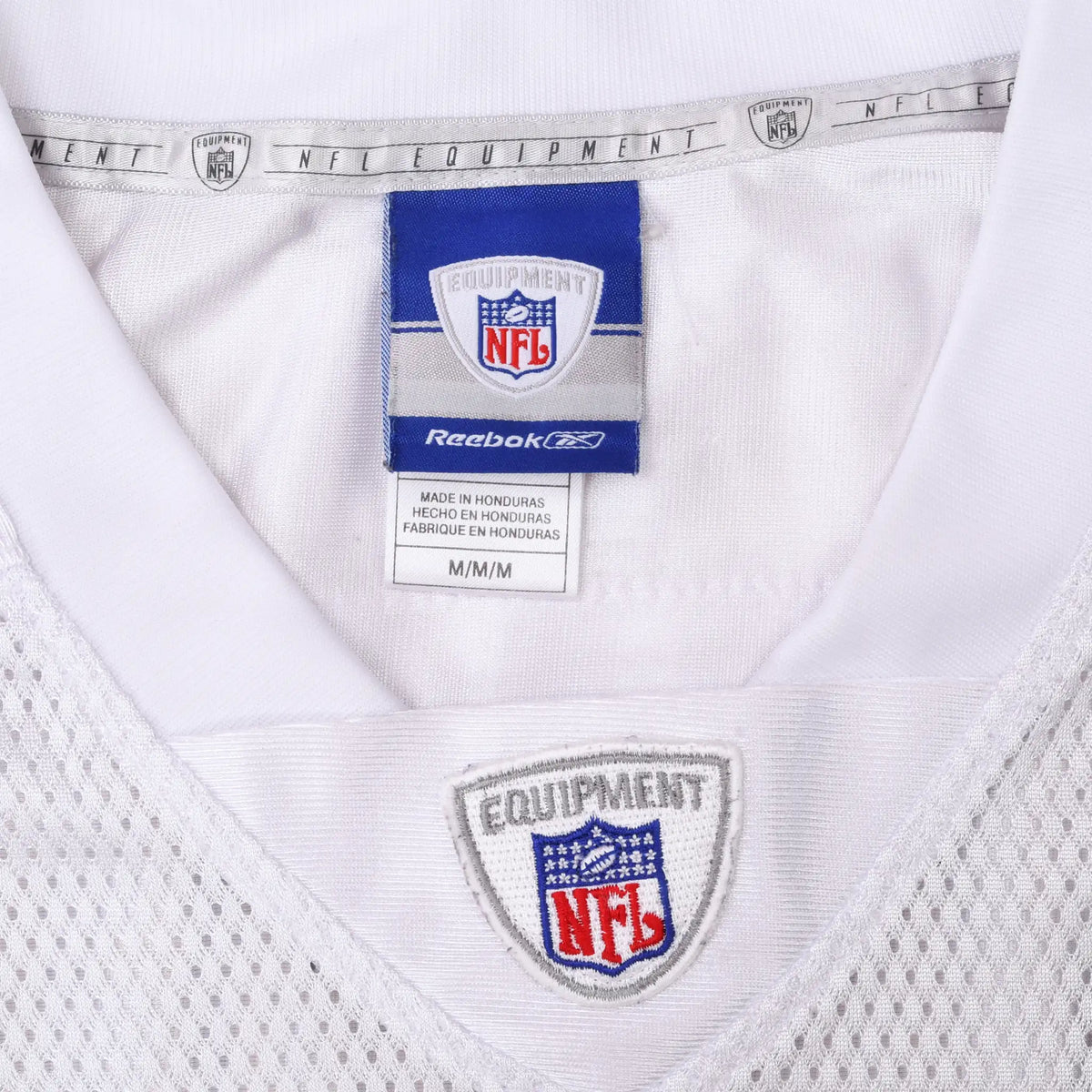 Close-up of Reebok NFL Equipment medium neck label and embroidered NFL collar shield