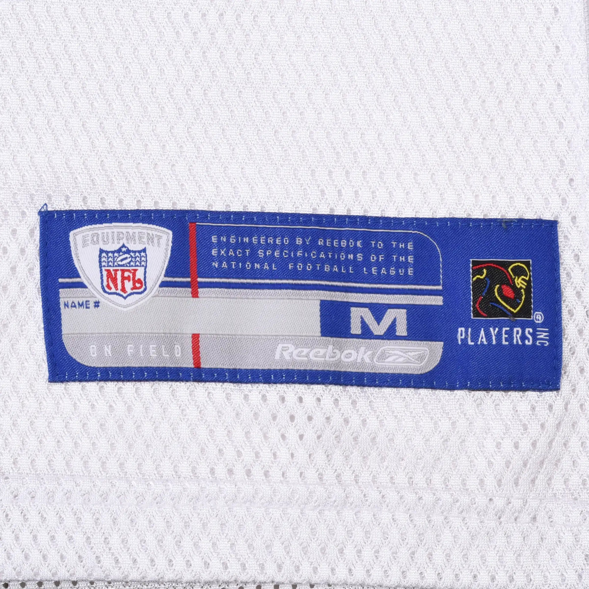 Close-up of Reebok NFL Equipment medium hem label and NFL Players logo