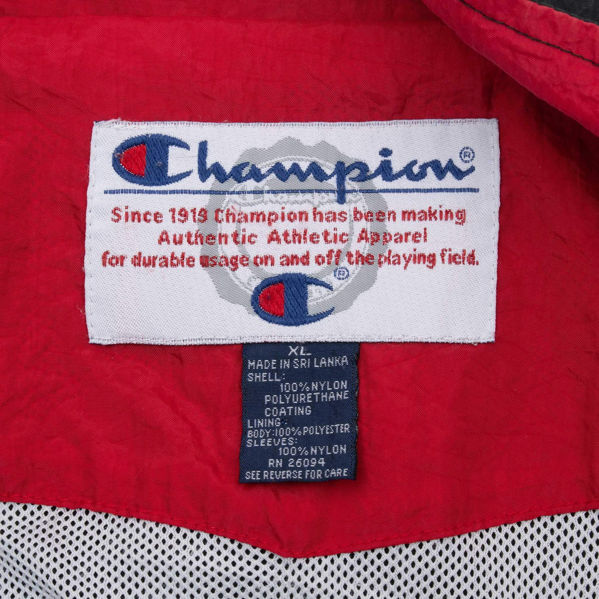 Champion neck label and XL care tag inside red windbreaker collar