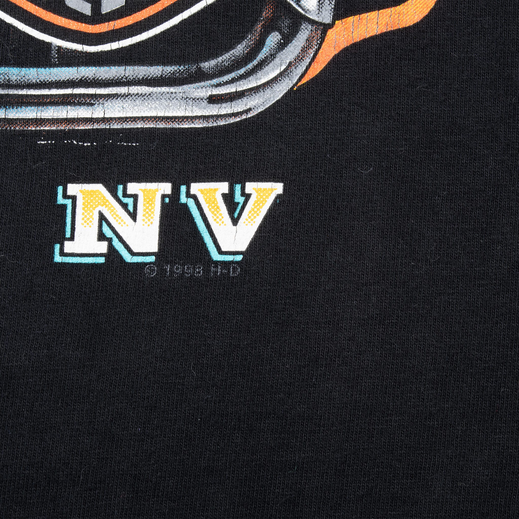 Close-up of NV lettering and faint copyright mark on the back print
