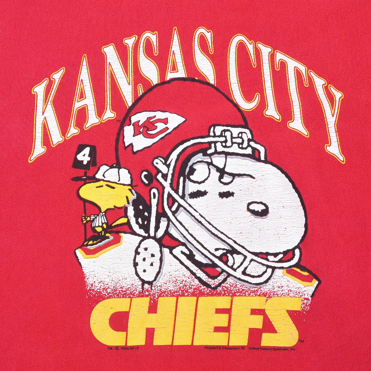 Close-up of Kansas City Chiefs print with helmeted Snoopy and Woodstock